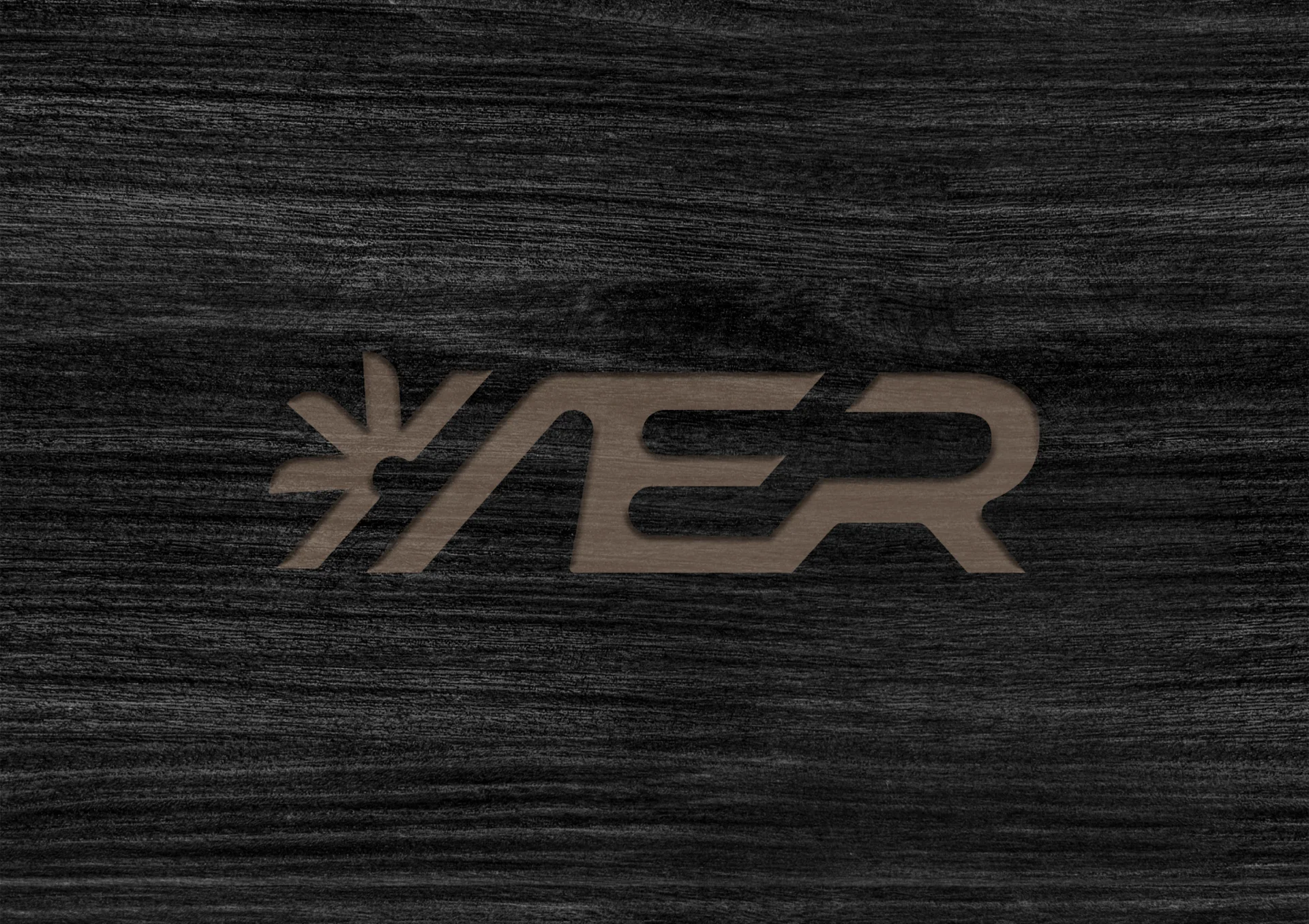 AER logo detail engraved into a dark material surface