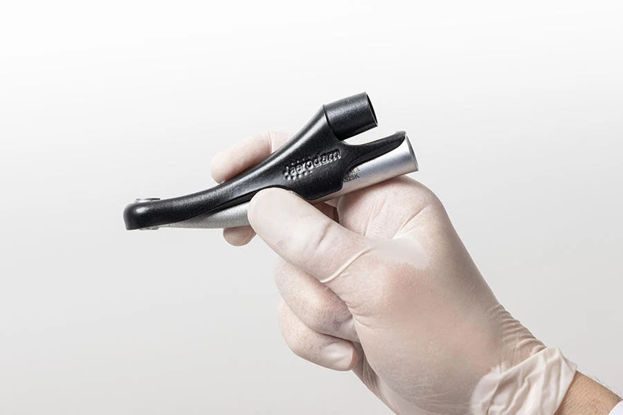 Aerodam accessory held in a hand to demonstrate its compact scale